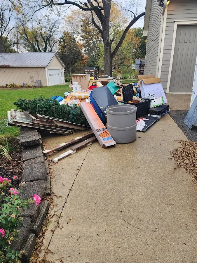 Dumpster being loaded with debris for Estate Cleanout Dumpster Rental in Dickinson